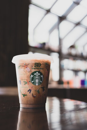 Bangkok, Thailand - December 2, 2022 : Starbucks iced Mocha on wood table. Starbucks ice beverage by coffee brand originated in USA.のeditorial素材