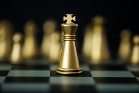 Golden king chess standing stand in front of golden chess pieces background. The concept of leaders in good organizations must have a vision and can predict business trends and assess competitors.の写真素材