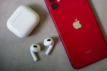 Bangkok, Thailand - December 10, 2022 : Airpods 3 with wireless charging case and I phone 11 red colour. Top viewのeditorial素材