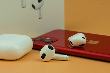 Bangkok, Thailand - December 24, 2022 : New AirPods 3 third generation. Headphones from the apple company with iPhone 11.のeditorial素材