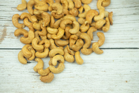 Directly above shot of tasty cashew nuts on wood table.の写真素材