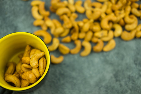 Top view and close up of roasted cashew nuts used as a snack.の写真素材