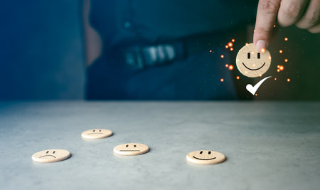 Questionnaire best excellent business services rating customer experience. Chooses a happy face on wood block cube. Satisfaction survey. Good comparison.の写真素材