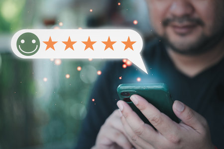 Happy man hand using smartphone with popup five star icon for feedback review satisfaction service,...