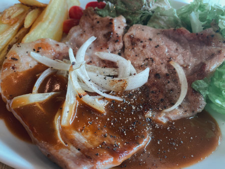 Grilled black pepper pork steak with french fries. Closed up picture