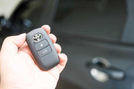 Bangkok, Thailand - February 25, 2023 : Keyless remote for car or vehicle with Toyota logo with copy space for text. Key from all new Toyota YARIS ATIV in hand.のeditorial素材