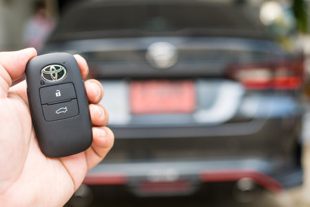 Bangkok, Thailand - February 25, 2023 : Keyless remote for car or vehicle with Toyota logo with copy space for text. Key from all new Toyota YARIS ATIV in hand.のeditorial素材