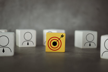 Dartboard target icon on yellow block and the team businessman icon on the wood block. Teamwork goal and target planning. Business achievement and objective target. Team growing concept.の写真素材