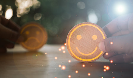 <p>Satisfaction survey concept. Customer services best excellent rating experience. Customer hand chooses and gives a happy face on circle block. Feeling good, world mental health day concept</p>の写真素材