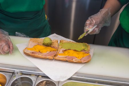 Bangkok, Thailand - March 4, 2023 : Subway staff is cooking sandwich at Subway shop in Thailand. Subway is an American fast food restaurant franchise that sells sandwiches and salads.のeditorial素材