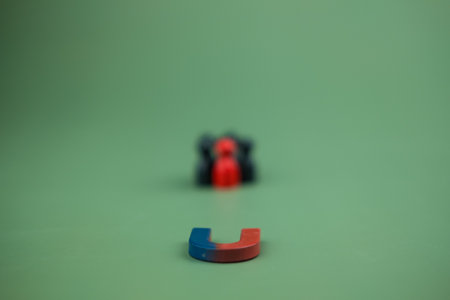 Close up of horseshoe magnet with peg doll background. Human resources HR management recruitment employment headhunting concept. Officer looking for employee in employees selection.の写真素材
