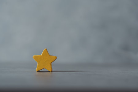 One wooden yellow star shape with an empty spec. Cute starの写真素材