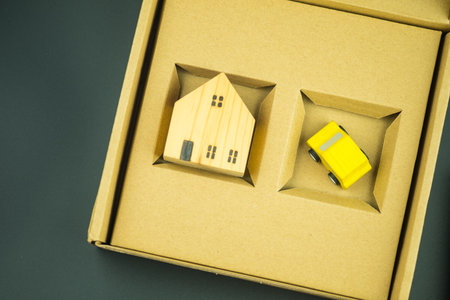 Insurance for house and car concept. Wooden house and wood car in brown box. Family home, Protection insurance. New home and new carの写真素材