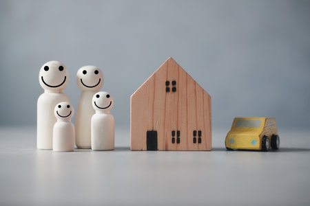 Happy wooden human family figure peg dolls with home and car. Money saving concept to build a family, marriage, family planning. Reserve money for future use of life partner. Success familyの写真素材