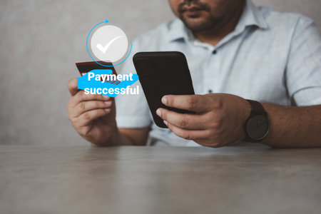 Man using smartphones for payment online at home. Cashless, contactless technology and money transfer concept. Transferring money online using applications to send and receive money on smartphones.の写真素材