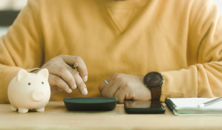 Man calculating income and expenses family financial account for step up growing family to profit and saving money. Saving money for future plan concept. Family budget bill payment checklist concept.の写真素材