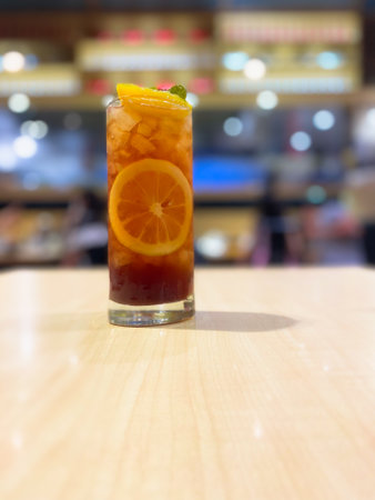 Glass of tasty iced tea with lemon in a glass on wood tableの写真素材