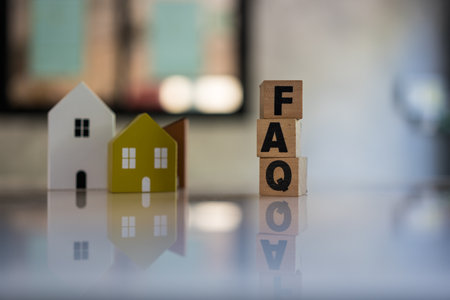 Cubes with message FAQ with wooden home. Quesiton and answer about housing problemsの写真素材