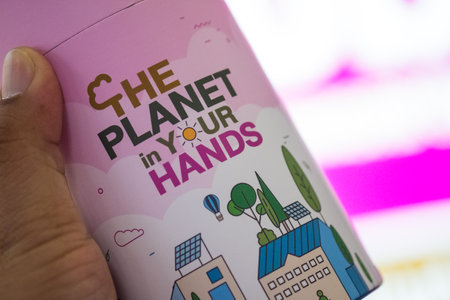 Bangkok, Thailand - April 1, 23 : Government Savings Bank give for piggy banks when your deposit money on 111th anniversary day. The piggy bank concept of The planet in your hand and made from rice straw pulpのeditorial素材