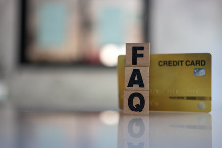 Cubes with message FAQ with a yellow credit card, credit card information web faq, Help desk customer service with credit cardの写真素材