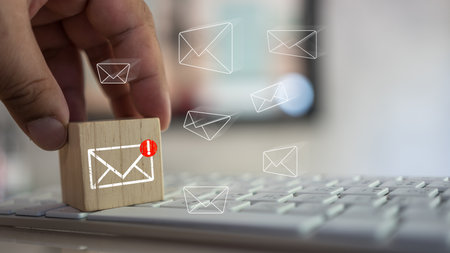 Man touching cube block with envelope and notifications symbol icon for the new E-Mail message inbox. The concept of computer browsing communicationの写真素材