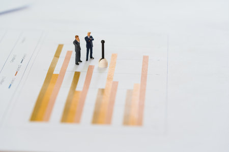 Miniature business people having meeting standing on graph with copy space using as background money, financial, business concept. Graph with performance as strategy concept and business conceptの写真素材