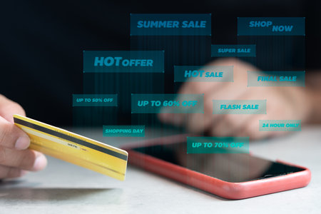 Online payment man hand holding a credit card and using a smartphone for online shopping with icon promotion for shopping. Payment credit card application and big shopping promotionの写真素材