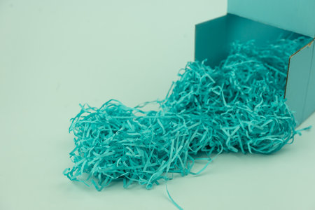 Blue box with blue shredded paper packing material for your product placementの写真素材