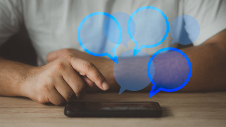 Man using mobile phone chat applications on digital devices social network chat of round blank...