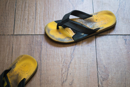 Old yellow sandals, yellow flip-flopsの写真素材