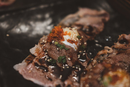 Grilled beef topping egg sushi Japanese food with wasabi dipping soy sauce on the plate. Close upの写真素材