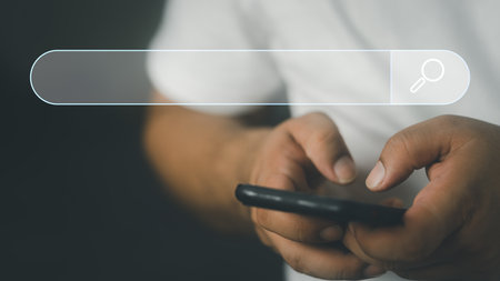 Data Search Technology Search Engine Optimization. Man's hands are using a smartphone to find what they are interested and Searching for information. Using Search Console with your website.の写真素材