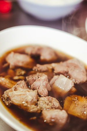Braised pork or stewed pork in a white bowl that is popular in Thailand eating with rice or noodles. Close upの写真素材