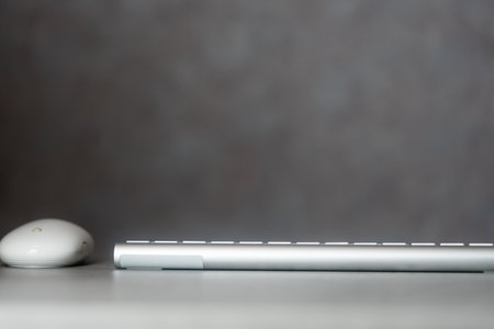White computer mouse and white keyboard on table with copy spaceの写真素材