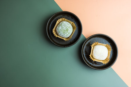 Green tea Matcha and milk Mochi ice cream on two background colourの写真素材