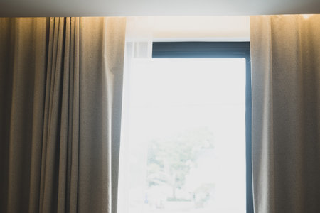Window with brown curtains in simple room interior. Close upの写真素材