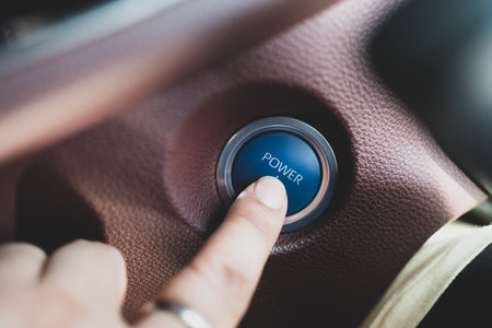 Close up of male finger pressing the engine start button in the car. Start and stop button. Concept of transportation and technology. keyless technologyの写真素材