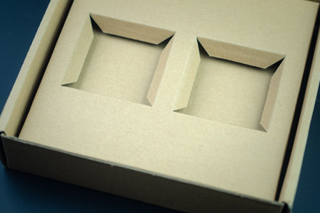Empty two hole brown opened empty box made of paperboard. Horizontal orientation. View from above. Mockup boxの写真素材