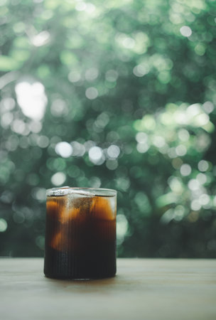 Iced americano in glass against nature background. Summer drinkの写真素材