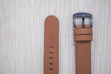Luxury fashion leather watch band on a wood table. Top view
