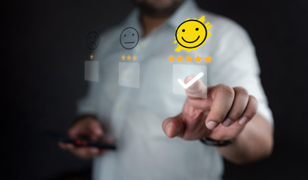 Man touching the virtual screen on the happy face icon and five stars to give satisfaction in service. Opinion rating very impressed. Assessment testimonial customer service and feedback concept.の写真素材