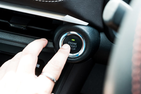 Owner finger about to touching and press button function start and stop luxury car engine in the...