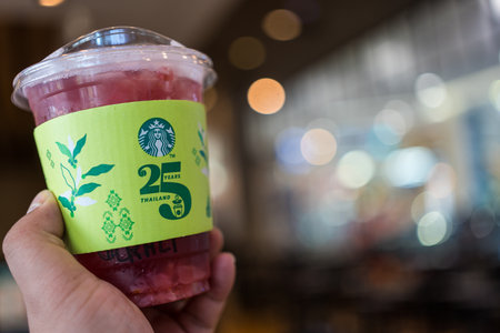 Bangkok, Thailand - August 22, 2023 : Green paper cup sleeve of  Starbucks Thailand celebrates 25...