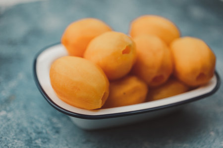 Sweet Yellow Marian Plum from Thailand. Peeled plango fruit. Tropical exotic summer fruit called a sweet and sour taste.の写真素材