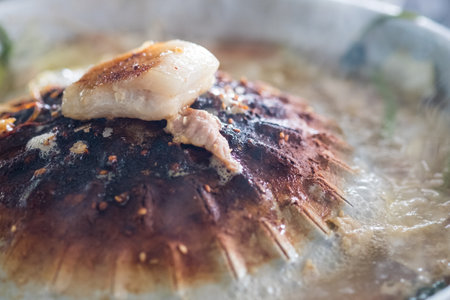 Close up of streaky pork on burnt and dirty pot. Thai style cuisine is called Moo Ka Ta. Thai...