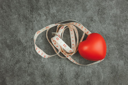 Close up red heart with measuring tape, heart check up. Healthy heartの写真素材