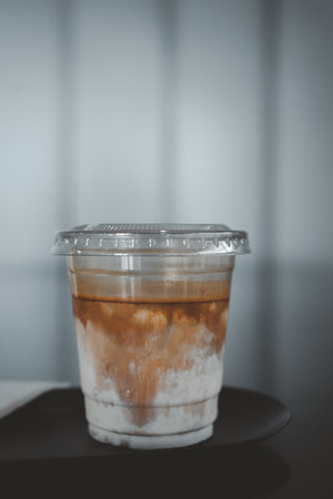 A Cup of the dirty coffee menu, layer separation of espresso and milk on the table.の写真素材