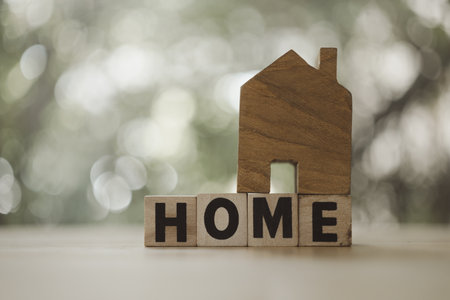 Small wooden house with text HOME with copy space. Business and loans conceptの写真素材