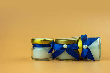 Aroma scented candle for gift for the guests at the wedding ceremony wrapped with bow blue.の写真素材