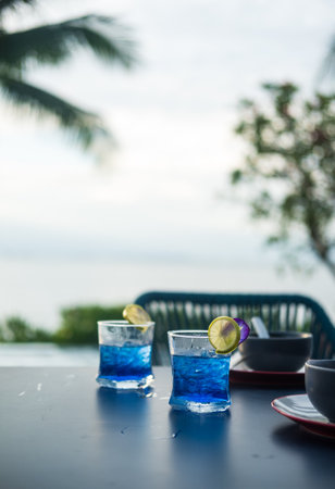 Summer fresh drink butterfly pea drink and slice of lime with empty bowl on table dinner. Selective...